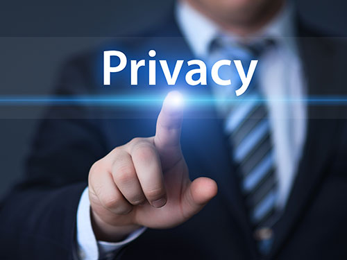 businessman with finger touching the word privacy on a virtual screen