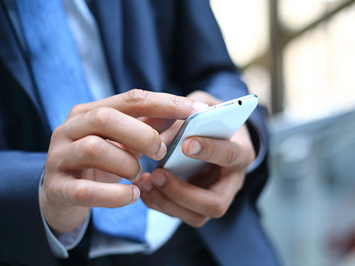 close up of a businessman using a mobile smartphone